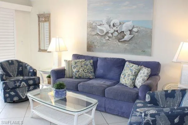 Living room featuring light tile pre Ian