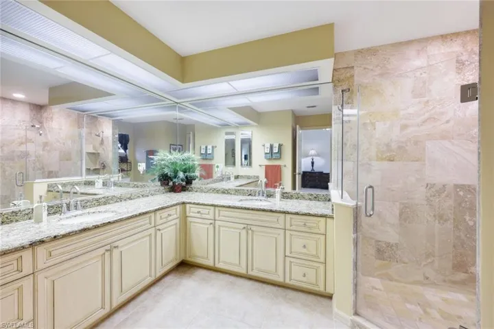 Bathroom with tile patterned flooring, vanity, and an enclosed shower