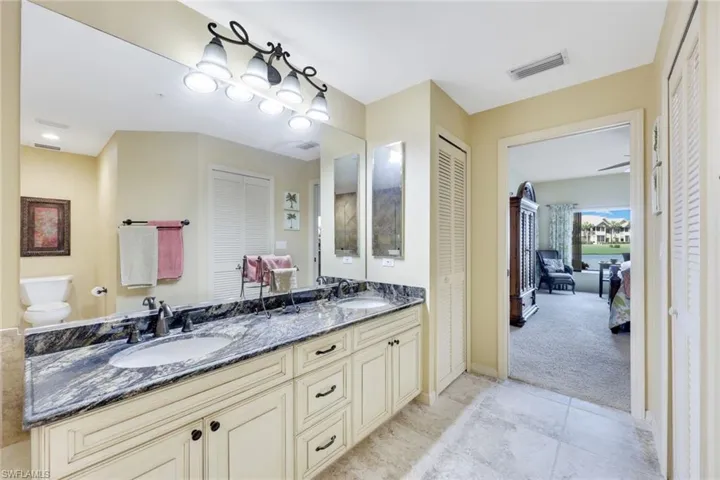 Bathroom with tile patterned flooring, vanity, and toilet