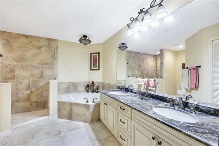 Bathroom with vanity and shower with separate bathtub