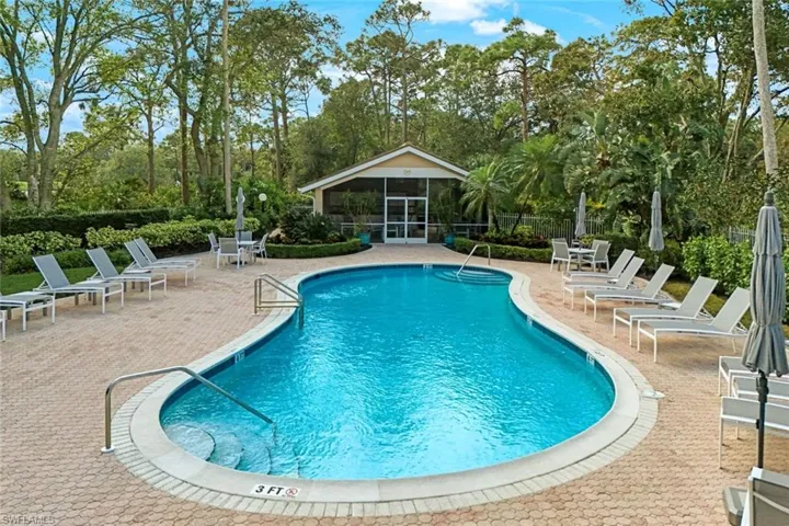 View of swimming pool featuring a patio and a sunroom