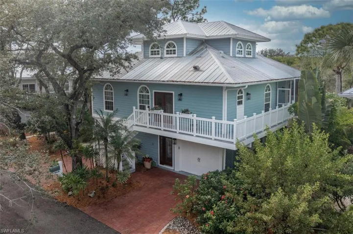 Key West Style Home featuring a metal roof