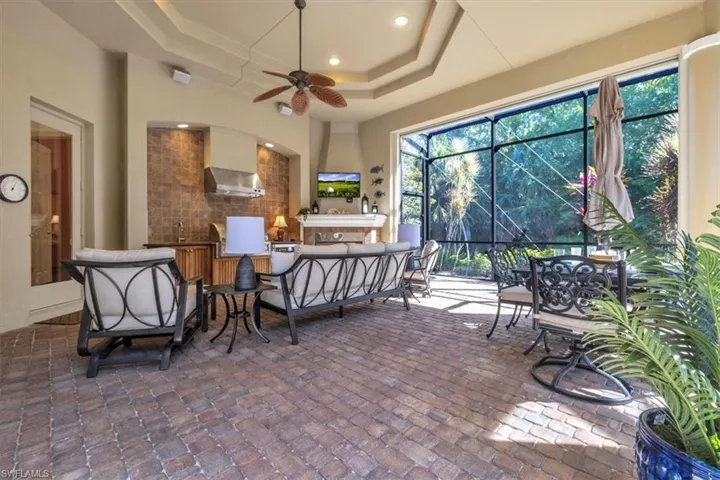 View of patio / terrace featuring ceiling fan, a lanai, outdoor lounge area, and a sunroom