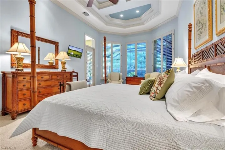 Bedroom featuring ceiling fan, crown molding, carpet, and coffered ceiling