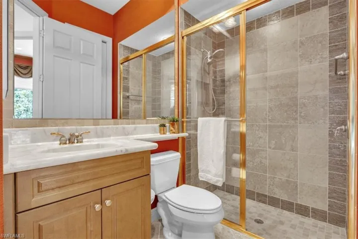 Bathroom featuring vanity and a stall shower