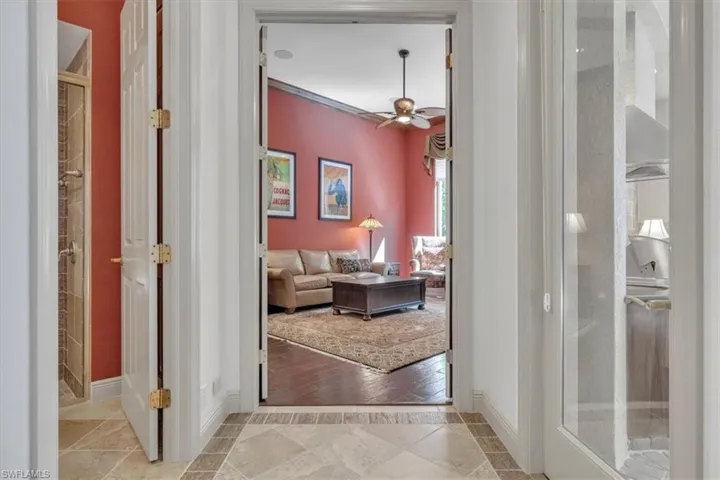 Corridor featuring inlaid floor details and baseboards