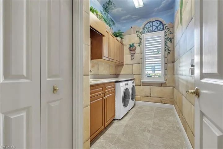 Laundry room featuring cabinet space and washing machine and clothes dryer