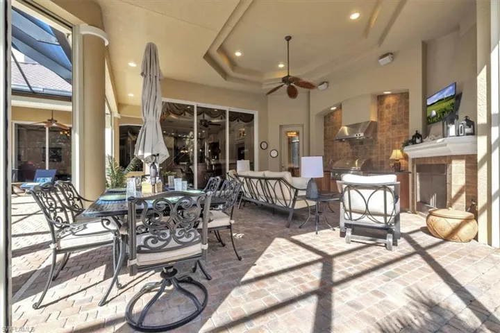 View of patio featuring ceiling fan and an outdoor kitchen / dining area