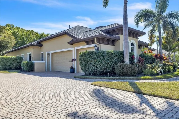 View of property exterior with stucco siding, driveway, and an attached garage