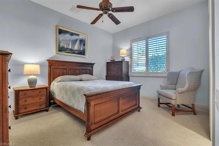 Bedroom with light carpet and ceiling fan