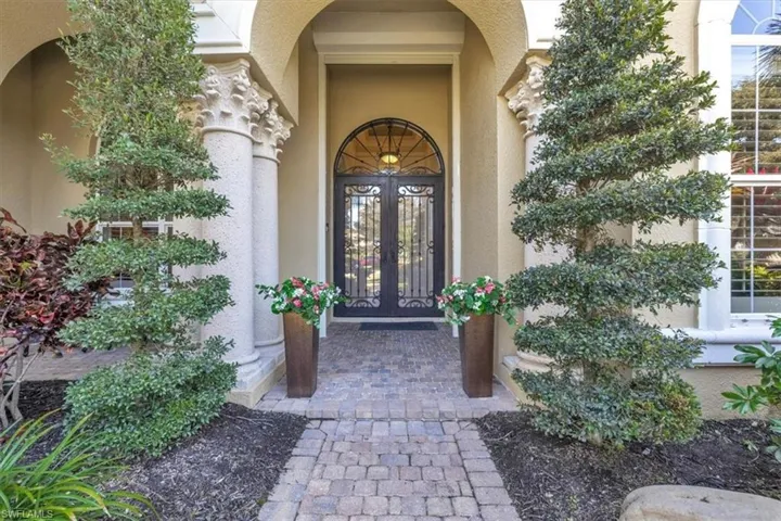 View of exterior entry featuring french doors and stucco siding