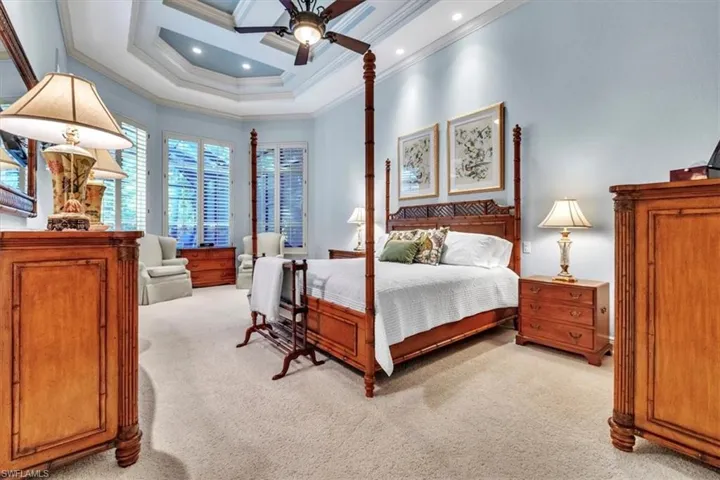 Bedroom with light carpet, ceiling fan, ornamental molding, and recessed lighting