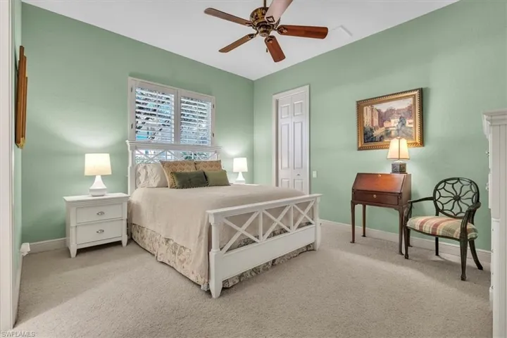 Bedroom with a closet, carpet floors, and a ceiling fan