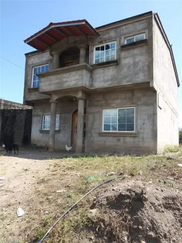 View of front of property with a balcony