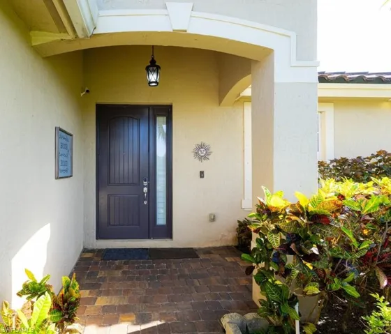 Doorway to property featuring stucco siding