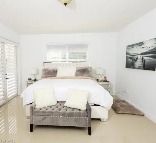 Bedroom with access to exterior, multiple windows, and tile patterned floors