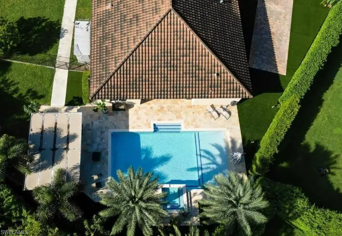 Aerial view of property and surrounding area featuring a pool