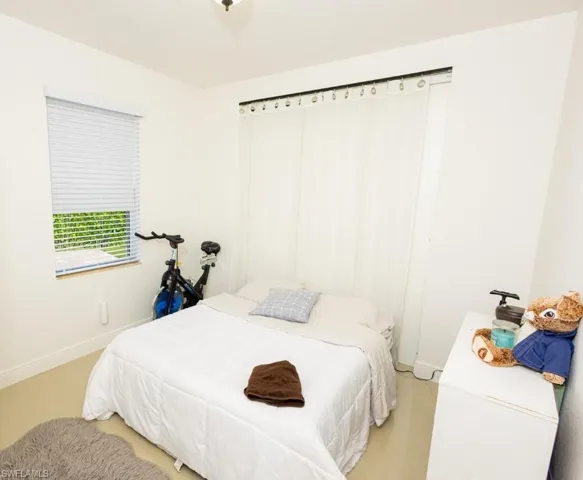 Tiled bedroom featuring baseboards