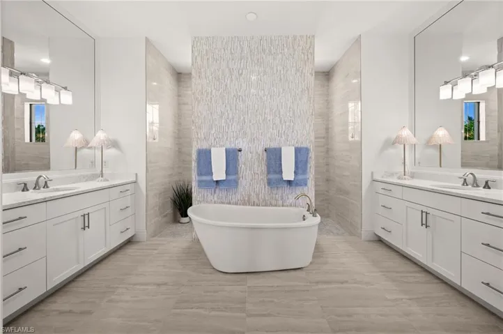 Primary bathroom with dual sinks, separate tub and passthrough shower