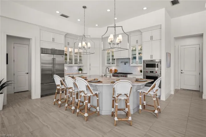 Island kitchen with custom countertop and Sub-Zero refrigerator