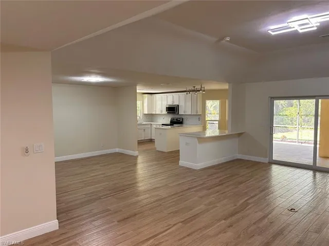 Unfurnished living room with light wood finished floors and plenty of natural light