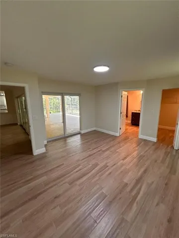 Unfurnished living room featuring light wood-style flooring