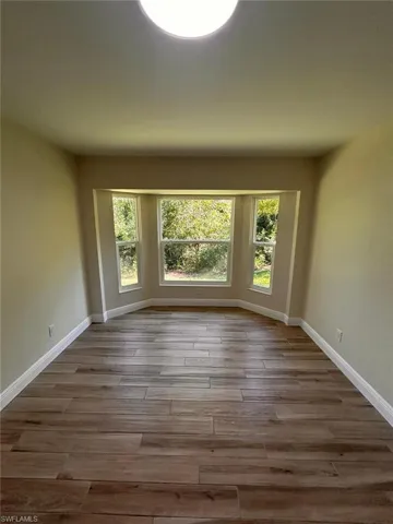 Spare room featuring healthy amount of natural light and light wood-style floors