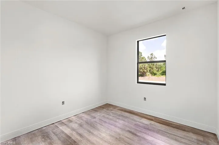 Spare room featuring wood-type flooring