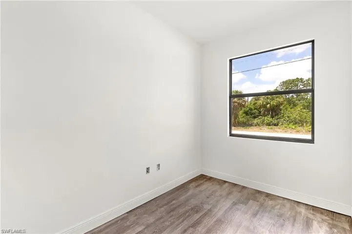 Empty room with hardwood / wood-style floors