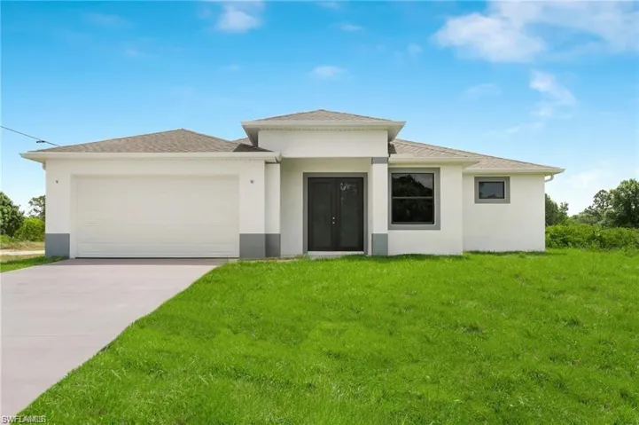 Prairie-style home with a garage and a front lawn