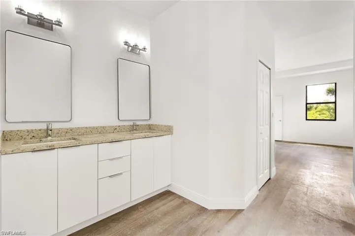 Bathroom with hardwood / wood-style floors and double sink vanity