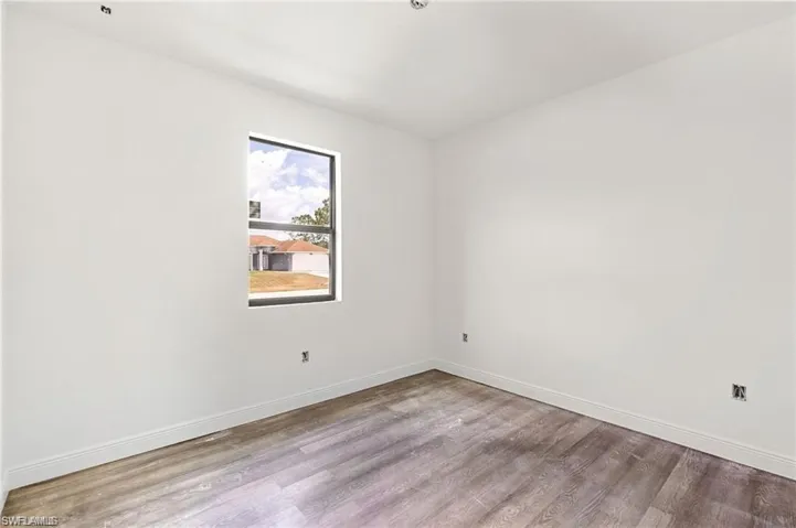 Empty room with wood-type flooring