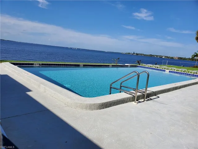 View of swimming pool featuring a water view