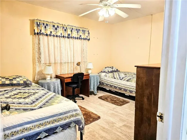 Bedroom with ceiling fan and wood-type flooring