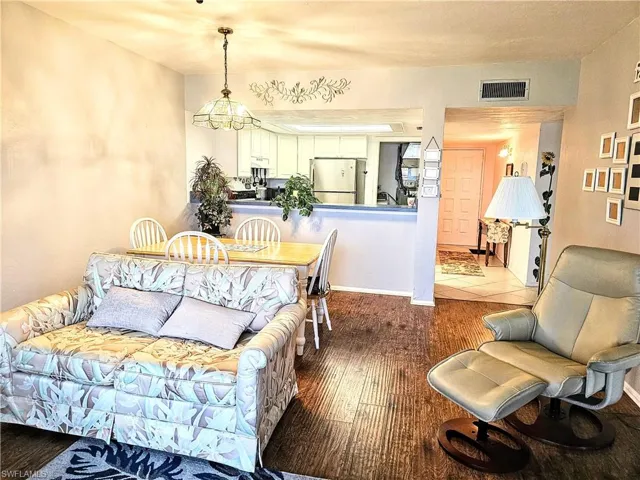 Living room with hardwood / wood-style flooring