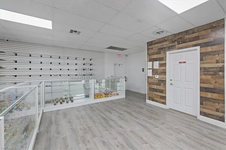 View of property's community featuring wood walls and a paneled ceiling