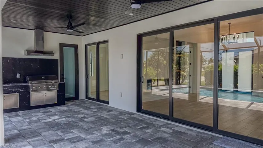 View of patio / terrace with area for grilling and ceiling fan