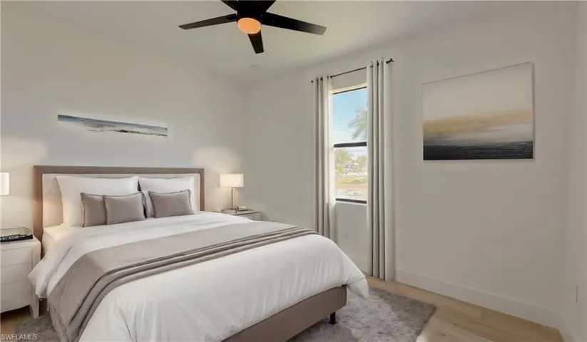 Bedroom with ceiling fan, baseboards, and light wood-style floors