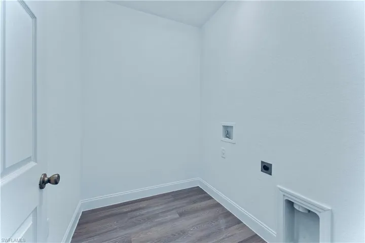 Laundry room featuring electric dryer hookup, hardwood / wood-style floors, and washer hookup