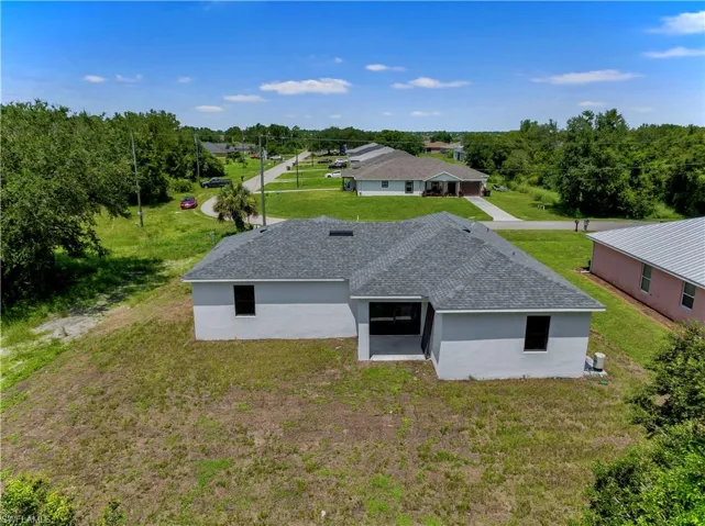 Back of property featuring a lawn
