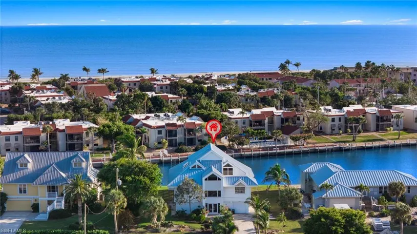 Aerial perspective of suburban area featuring a large body of water