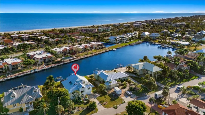 Aerial perspective of suburban area featuring a nearby body of water