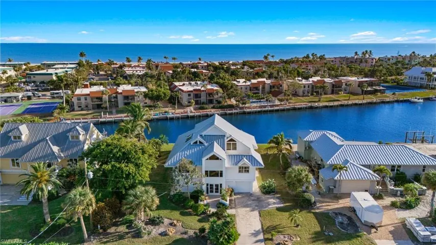 Aerial view of residential area featuring a large body of water