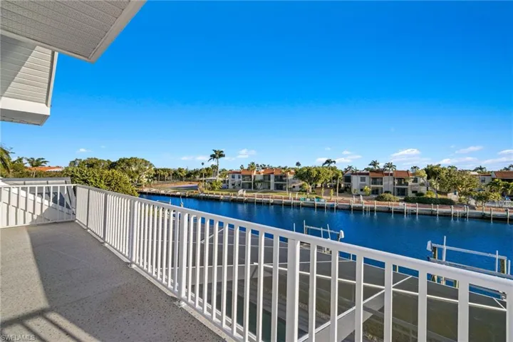 Balcony featuring a water view and a residential view