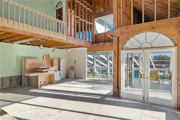 Living room with a high ceiling and french doors