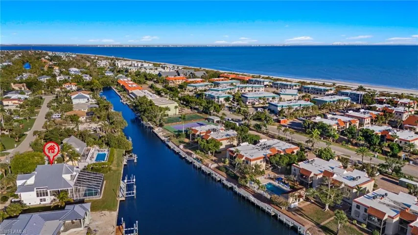 Aerial perspective of suburban area featuring a nearby body of water