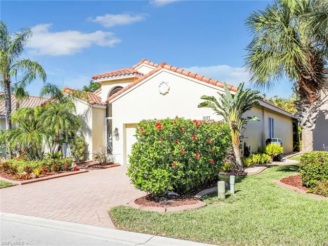 Mediterranean / spanish-style house with a garage and a front lawn