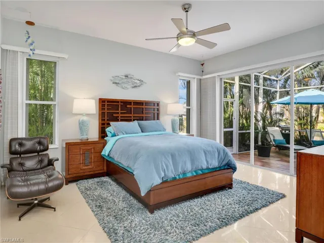 Tiled bedroom with access to exterior and ceiling fan