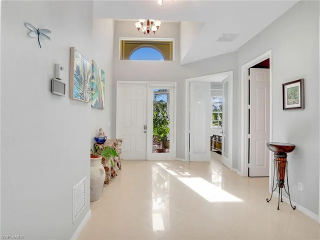Tiled entrance foyer featuring an inviting chandelier