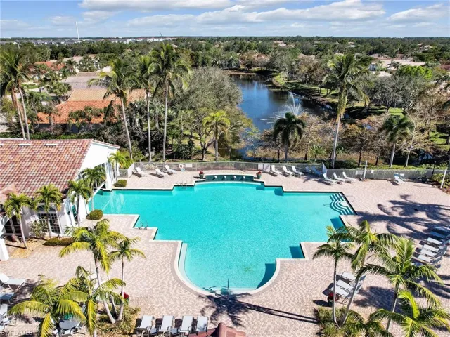 View of swimming pool with a water view and a patio